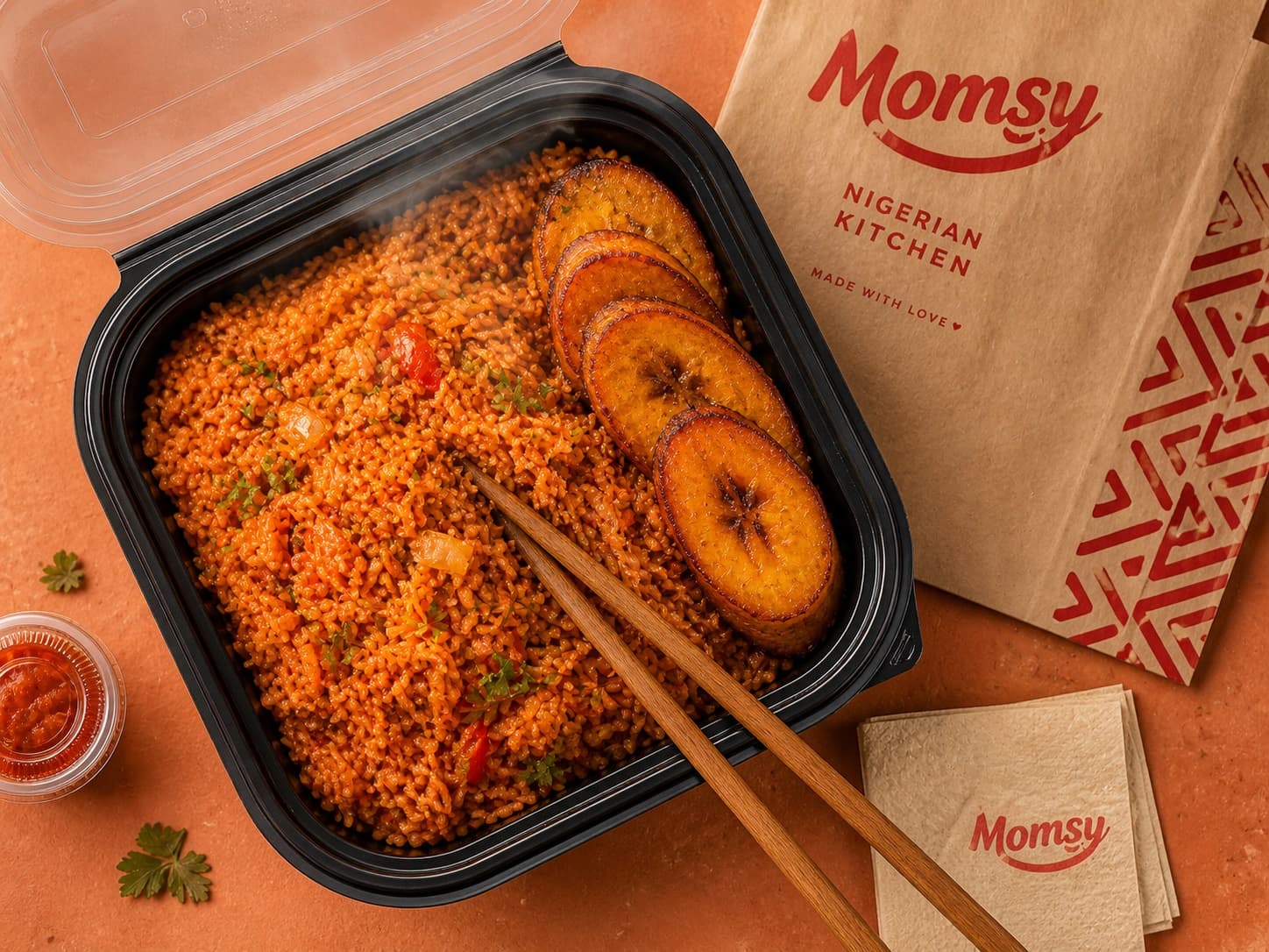 Steaming plate of jollof rice with grilled chicken and fried plantains